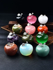 Macro shot of assorted natural crystal apples with rhinestone leaves on a wooden tray