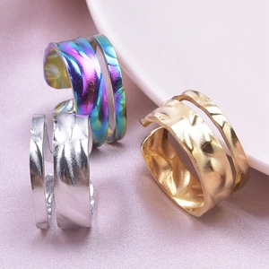 Macro shot of 304 stainless steel rings with hammered texture on pink silk fabric