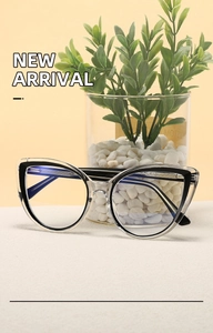 Detail of cat-eye glasses with transparent black frame and visible metal core