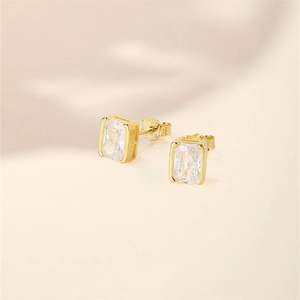 Detailed macro view of S925 sterling silver gold earrings with rectangular crystals
