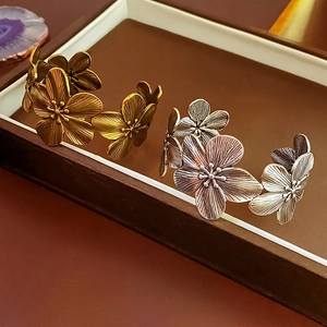Vintage metal flower cuff bracelet with antique gold and silver finishes in floral design