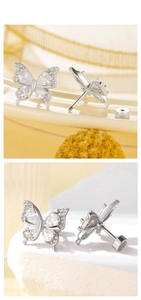 Macro shot of silver butterfly stud earrings with zircon inlay and screw-on back closures