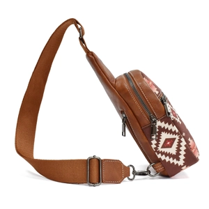 Side view of bohemian canvas chest bag with brown leather accents and ethnic patterns
