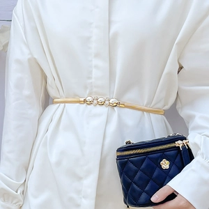 Elegant gold elastic waist chain with pearl and rhinestone buckle on white shirt