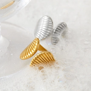Minimalist stainless steel shell rings in gold and silver finish with bubble backdrop