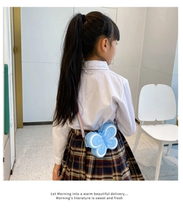 Detailed view of sky blue butterfly silicone bag with colorful rainbow shoulder strap