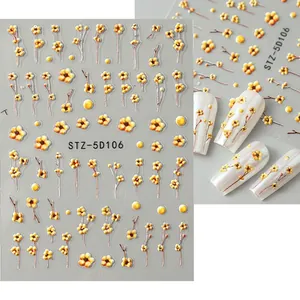 Detailed 5D embossed nail stickers featuring yellow plum blossoms on a light grey background