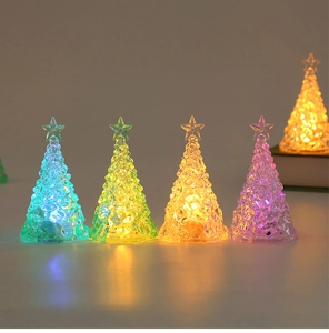 Macro view of crystal-textured LED Christmas trees glowing in blue, green, and warm yellow