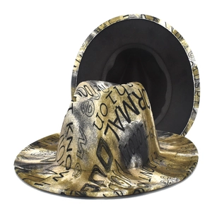 Wide brim fedora hat featuring black and gold tie-dye graffiti print in a street style