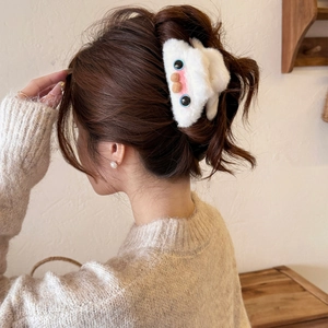 Cute white plush hair claw clip featuring cartoon monster face with blue eyes and pink cheeks