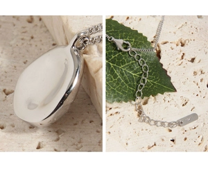 Macro detail of S925 sterling silver oval pendant with adjustable chain and lobster clasp