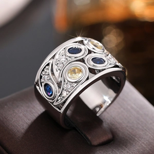 Vue détaillée d'une bague large bohème ajourée avec pierres bleues, jaunes et blanches