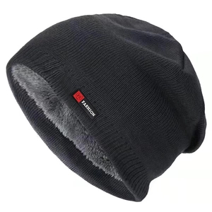 Detail of winter beanie showing thick grey fleece lining and black knit texture