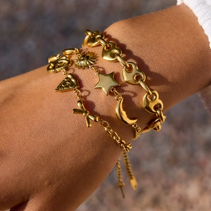 18K gold plated stainless steel layered bracelets with heart and bow charm on wrist