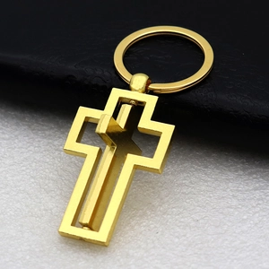 Rotating gold metal cross keychain shown at a 45-degree angle with polished finish