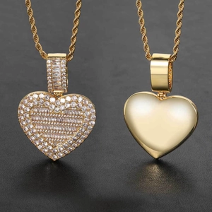 Detail of hip hop heart photo locket necklace with gold plating and paved zircon stones