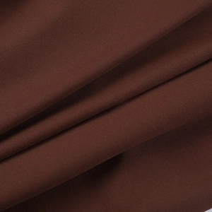 Close-up of dark brown polyester fabric with fine plain weave and soft draping folds