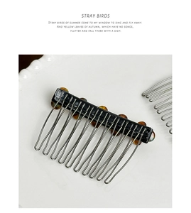 Macro detail of tortoiseshell acetate insert on vintage metal wire hair comb