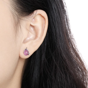 S925 sterling silver teardrop earrings with purple crystal shown on ear model