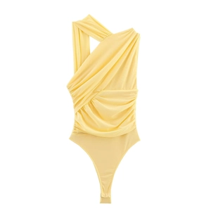 Detail of yellow one-shoulder bodysuit showing ruched texture and mesh fabric on white backdrop