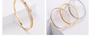 Detailed macro view of hypoallergenic hollow metal bangles with sparkling crystals