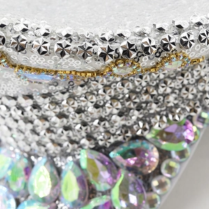 Close-up of silver sequins, metallic star studs, and rhinestones on a luxury captain hat