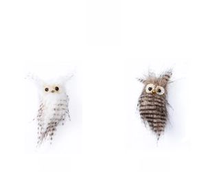 Detail view of white and brown plush owl ornaments with realistic feather textures