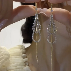 Elegant gold tassel earrings with rhinestone circles and shimmering butterfly fringe