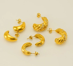 Close-up of gold-plated stainless steel earrings set featuring crystal-studded woven designs
