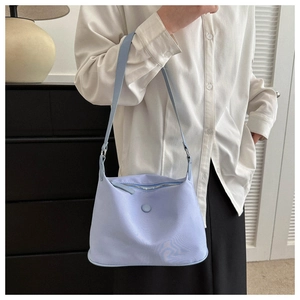 Detail of light purple Oxford fabric crossbody bag with zipper and button accent