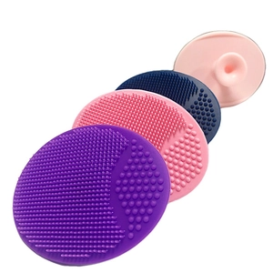 Set of four colorful silicone facial cleansing brushes with soft bristles and suction cups