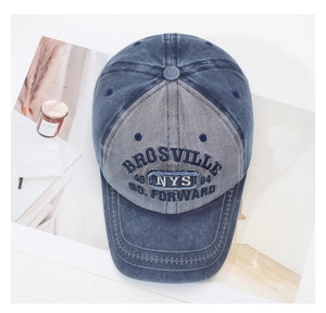 Close-up of vintage washed denim baseball cap with BROSVILLE embroidery on a flat layout