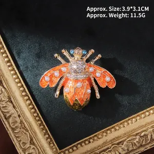 Macro view of vintage baroque bee brooch with enamel wings and inlaid pearls on velvet