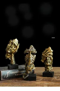 Close-up of Nordic resin sculptures showing intricate black and gold metal textures