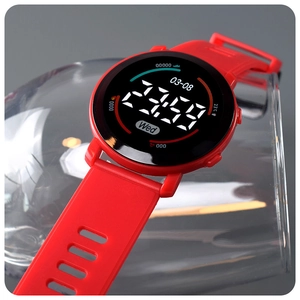 Macro detail of red digital sports watch displaying LED time and temperature on glass
