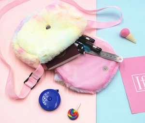 Internal view of plush rainbow crossbody bag showing storage space for school supplies