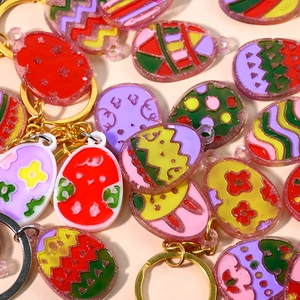 DIY Easter egg epoxy resin earring and keychain charms with colorful glitter patterns