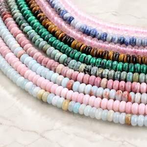 Macro shot of colorful 3mm natural gemstone beads including tiger eye and malachite strings