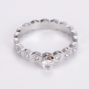 Macro shot of silver diamond-encrusted wave ring with a round center stone and polished finish