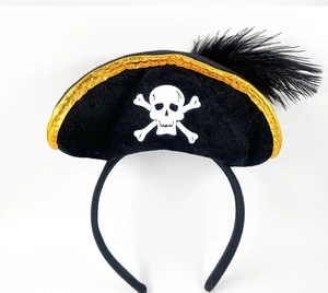 Detail of black pirate headband with skull pattern, golden trim, and feather decoration