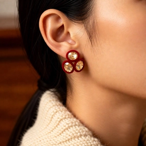 Detailed view of vintage red velvet earrings with sparkling golden crystal accents