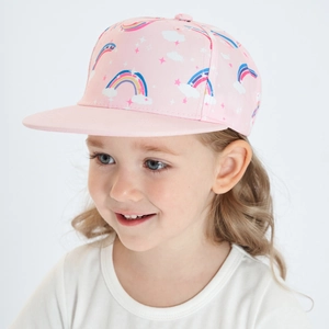 Close-up of pink children's snapback hat with rainbow and star prints on a young girl