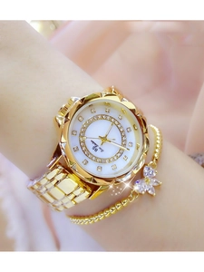 Detail of gold women watch with mother of pearl dial and matching butterfly bracelet