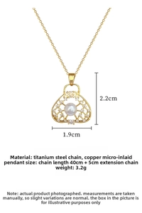 Detail showing gold plated hollow pendant with white pearl and sparkling crystals