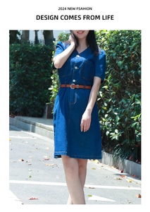 Detail of a dark blue denim V-neck dress with brown leather belt and button-up front