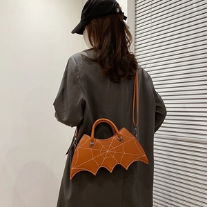 Close-up of brown PU leather bat shaped crossbody bag with spider web embroidery detail