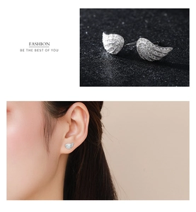 Macro view and model wearing S925 sterling silver angel wing earrings with cubic zirconia