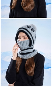 Detail of grey and black striped knitted balaclava with warm fleece lining and pompom