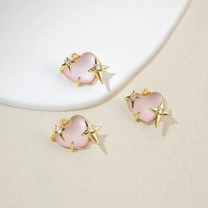 Detailed view of pink heart pendants with gold star accents and crystal zircons