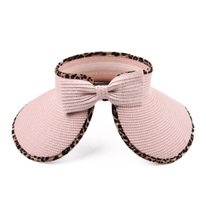 Detail of pink straw sun visor with leopard print trim and decorative bow on the back